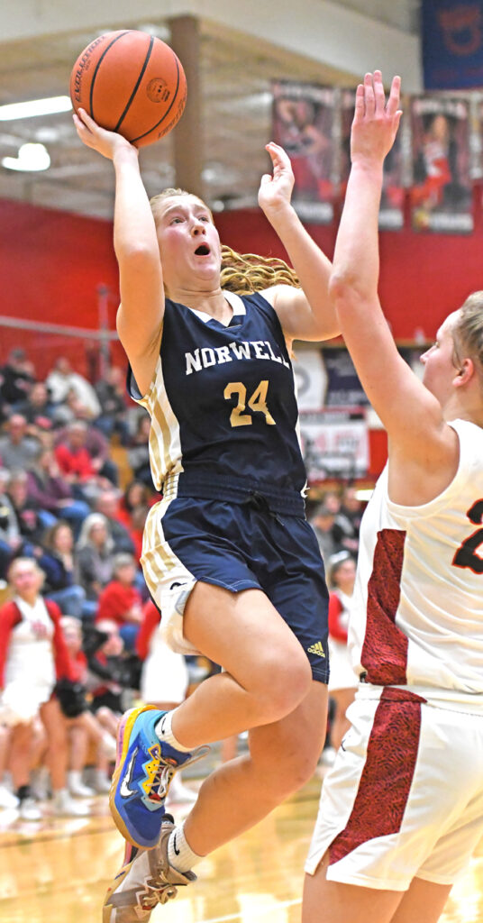 Makenzie Fuess drives into the lane for two points as the Knights slowly pulled away from the Vikings in the fourth quarter Friday night at North Arena in Huntington. (Photo by Glen Werling)